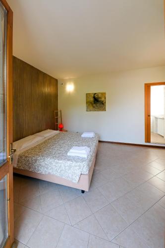 a bedroom with a large bed in a room at Locanda Dell'Era in Dorio