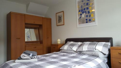 a bedroom with a bed and a dresser at The Apartment Bushmills in Bushmills