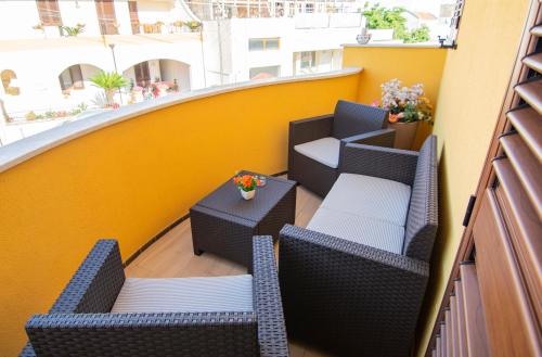 a balcony with chairs and tables on a building at Chiardiluna in Castro di Lecce