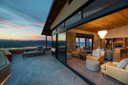 an open living room with a view of the mountains at Alkira Lodge in Brenton-on-Sea