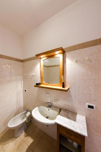 a bathroom with a sink and a mirror at Locanda Dell'Era in Dorio