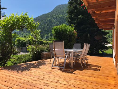 a table and chairs on a wooden deck at Haus Central Lofer in Lofer