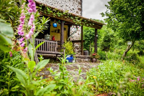 a house with a bench in the garden at Les Cavaleries in Nonards