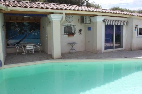a house with a swimming pool and a patio at LES JARRES BLEUES in Grillon