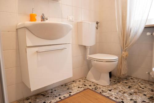 a white bathroom with a sink and a toilet at B&B Forever in Verona