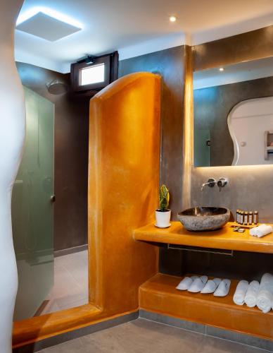 a bathroom with a sink and a mirror at Irene City Villas in Fira