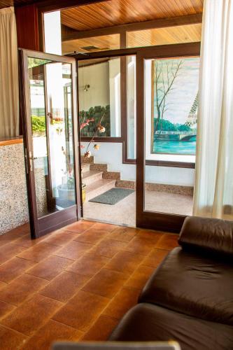 a living room with a couch and glass doors at Hotel Mabú in Ourense