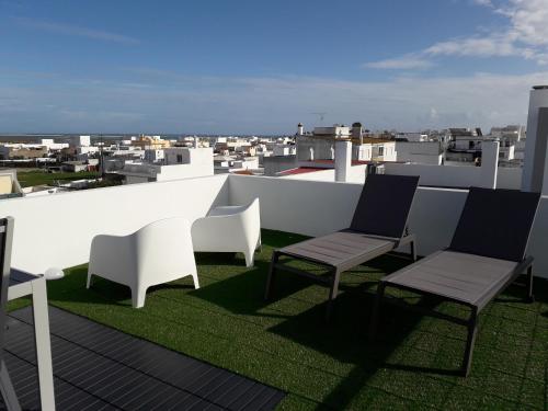 a group of chairs sitting on top of a roof at Casa da Sardinha in Fuzeta