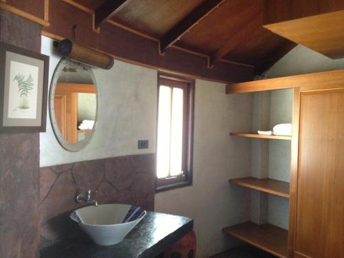 a bathroom with a sink and a mirror at Malibu Beach Bungalows in Chaloklum