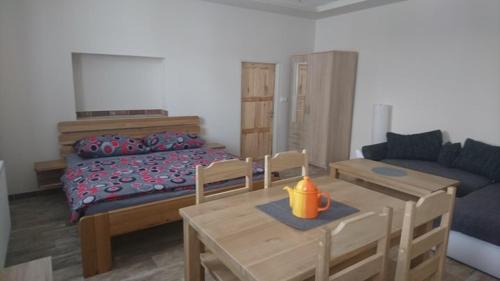 a living room with a bed and a table and a couch at Business apartmán in Žamberk