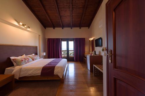 a hotel room with a bed and a window at Althea Apartments in Katakolon