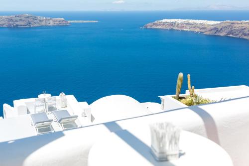 a view of the ocean from a white building at Dreaming View Suites in Imerovigli