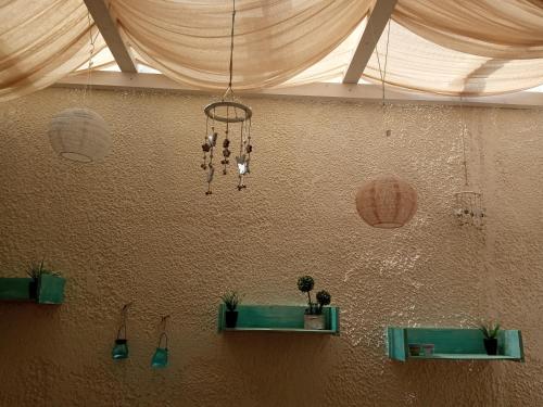 um quarto com um lustre pendurado numa parede em Alkyonari by Anna em Amoliani