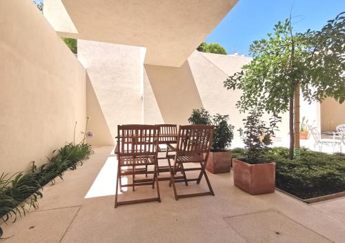 two chairs and a table on a patio at Casa René - Charming apartments in Almada