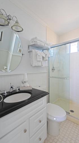 a bathroom with a sink and a shower and a toilet at Sea Crest in Amagansett