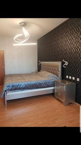a bedroom with a bed and a night stand at Apartament Mamaia in Mamaia