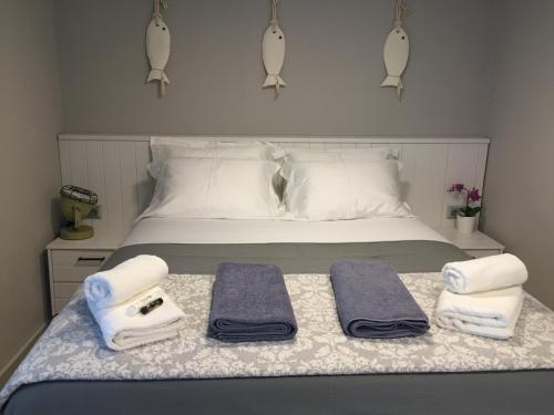 a bedroom with a bed with towels on it at Ananda Homes in Pefkohori