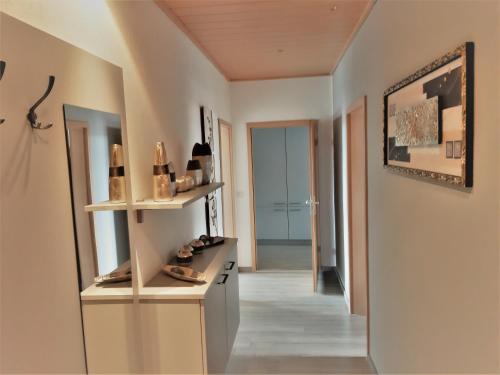 a hallway of a house with shoes on a shelf at Hotel Fabrice in Bad Klosterlausnitz
