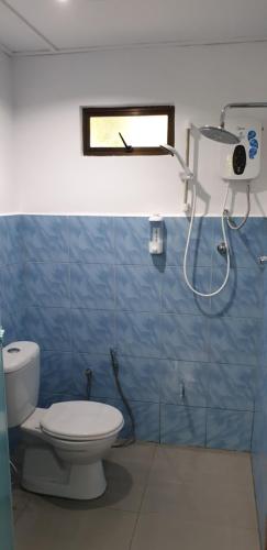 a bathroom with a toilet and a window at MRI Residence - Homestay in Sg Buloh with Swimming Pool - No Pork&Alcohol Allowed in Bandar Puncak Alam
