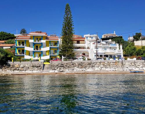 a group of buildings next to the water at Iris Apartments in Chrani