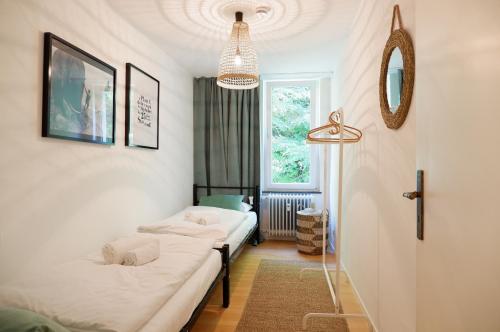 a room with two beds and a window at Apartment Zentral in Tübingen