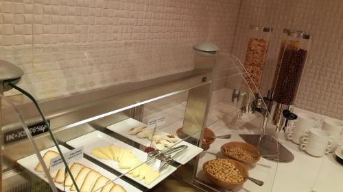a display case with various types of pastries and cookies at Warwick Ankara in Ankara