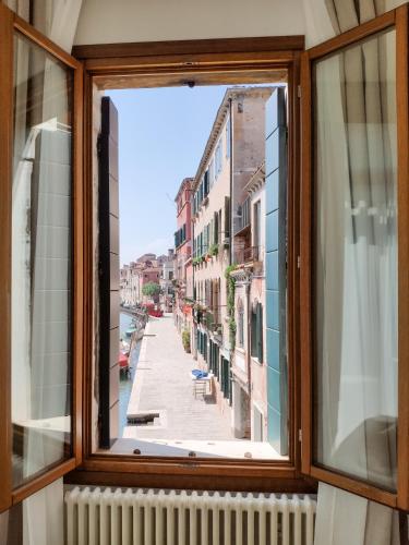 a window in a building with a view of a street at Canaletto Apartments in Venice