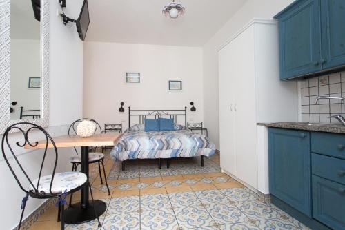 a bedroom with a bed and a desk and a table at Diana Brown B&B Affittacamere in Lipari