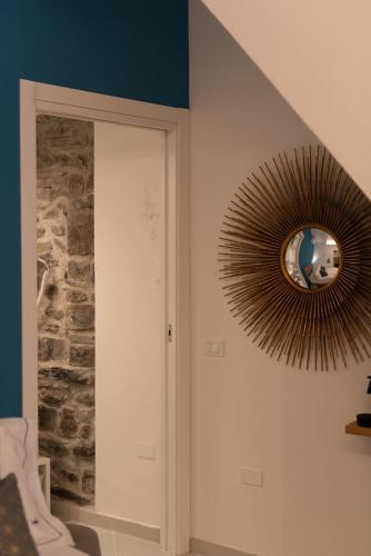a mirror hanging on a wall in a room at L'EMPORIO ROOMS in Manarola