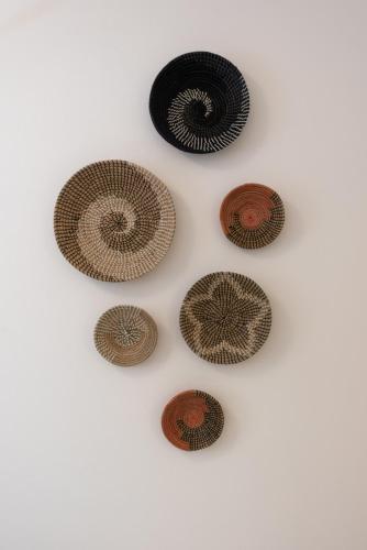 four brown and black disks on a white background at L'EMPORIO ROOMS in Manarola