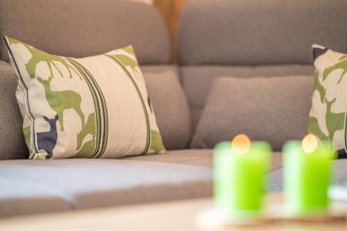 a living room with a couch with pillows at Residence Tamperhof in San Candido