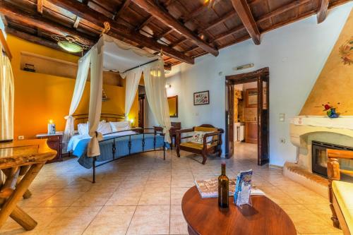 a large room with a bed and a fireplace at Idili in Panormos Rethymno