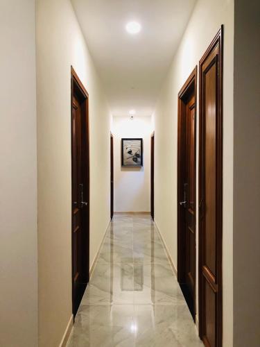 a hallway with two doors and a tile floor at Doha 2 Hotel Saigon Airport in Ho Chi Minh City