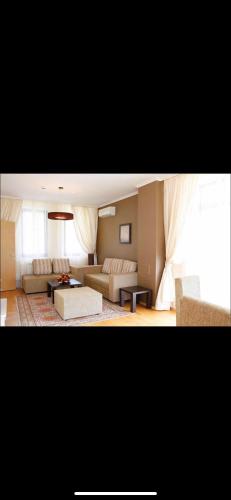 a large living room with a couch and a table at Pravets Resort Apartments in Pravets