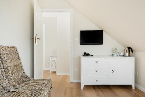 a living room with a white dresser and a tv at Villa Sedina in Rewal