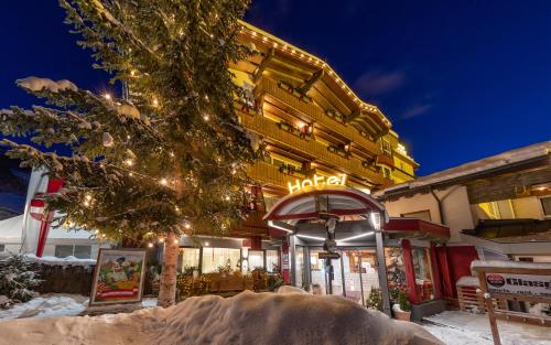 a building with a hotel sign in the snow at VÖTTER'S HOTEL in Kaprun - summer card included in Kaprun