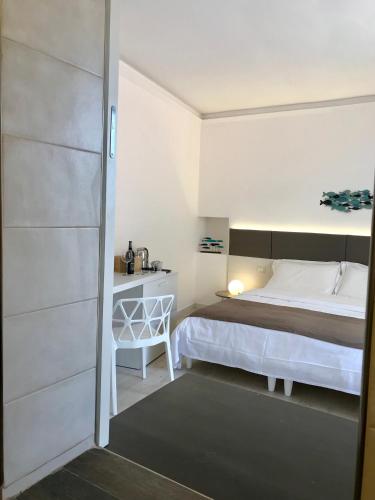 a small bedroom with a bed and a desk at Paradisea Taormina in Taormina