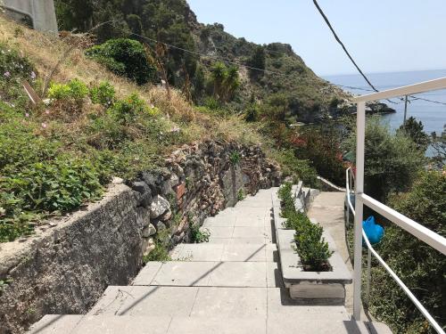 a stairway with plants on the side of a hill at Paradisea Taormina in Taormina