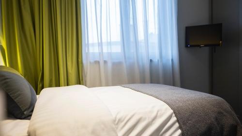 Un ou plusieurs lits dans un hébergement de l'établissement Livris Hotel