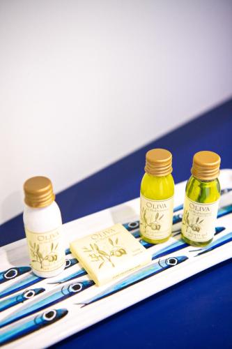 a tray with three bottles of honey on a table at Imperati Suites by Alcione Residence in Positano