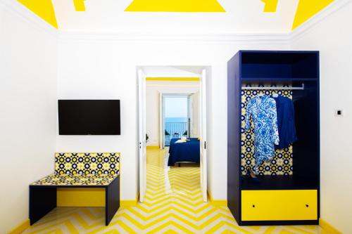 a room with a yellow and blue patterned floor at Imperati Suites by Alcione Residence in Positano