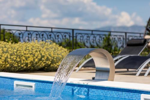 a water fountain in a swimming pool at Villa Zarra in Klimno