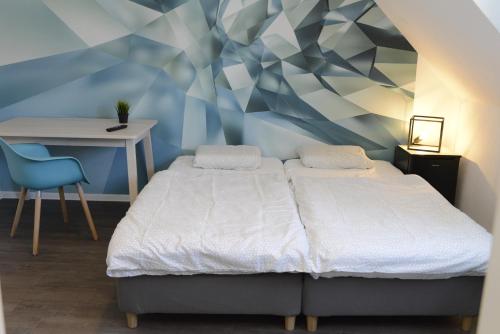 a bedroom with a bed and a desk and a chair at Pforzheim Ferienhaus in Pforzheim