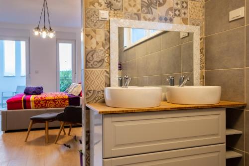 a bathroom with two sinks and a mirror at Villa Zarra in Klimno