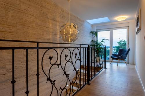 a staircase in a house with a wrought iron railing at Villa Zarra in Klimno
