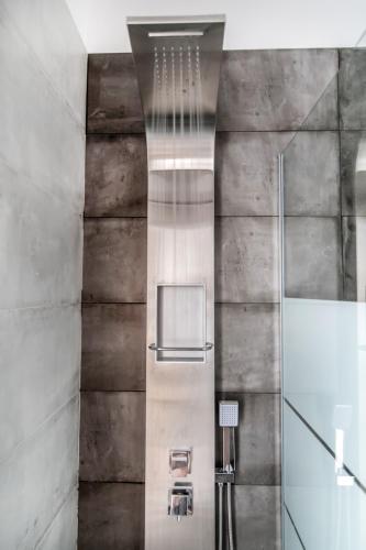 a bathroom with a shower with a glass door at Lux 'n Comfort Apartments in Tinos