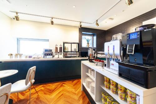 a coffee shop with a counter and a cafeteria at Ocean 2 Heaven Hotel in Busan