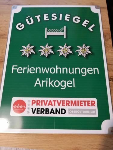 a green cake with a sign on a table at Ferienwohnungen ARIKOGEL Bad Goisern in Bad Goisern
