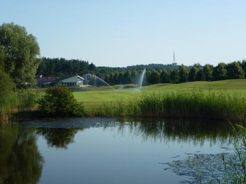 a pond in front of a golf course at Seeblick Kemnitz in Werder