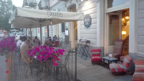 a restaurant with tables and chairs and an umbrella at La Boqueria in Bra